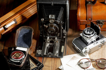 Old vintage cameras on an old background.