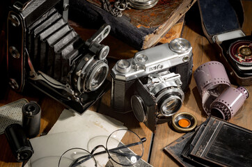 Old vintage cameras on an old background.