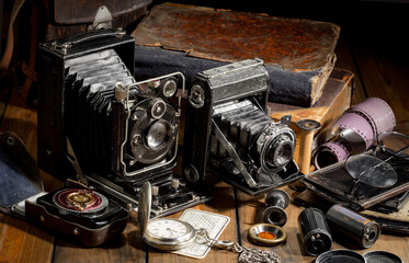 An old camera in a composition on an old background, on a table