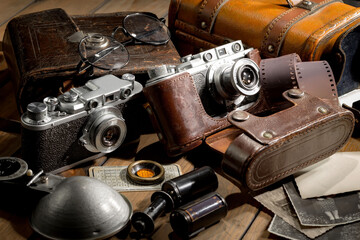 An old camera in a composition on an old background, on a table