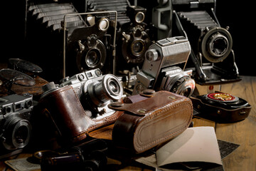 Old vintage photo cameras on an old background.