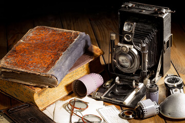 Old camera in the studio on an old background