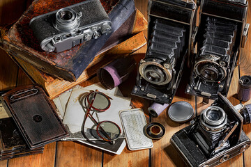 Old vintage photo cameras on an old background.