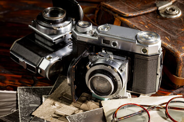Fototapeta na wymiar Old vintage cameras on an old background.