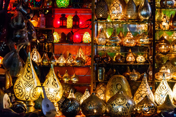 Fototapeta premium Electric luminous colorful mosaic lamps in oriental style as tourist souvenirs at night street market in Sharm El Sheikh, Egypt