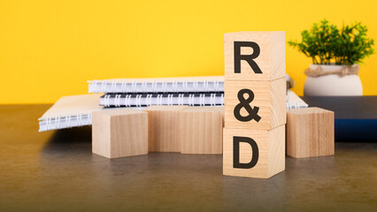 rd - text on wood cubes stack, yellow background