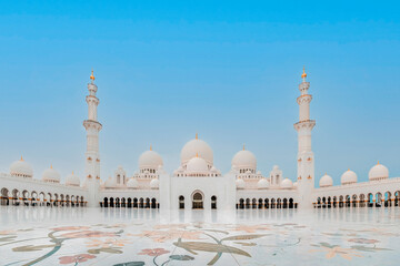 Fototapeta na wymiar Exterior photo of the beautiful Sheikh Zayed Mosque with its massive courtyard in Abu Dhabi, United Arab Emirates 