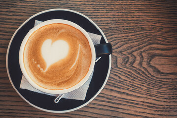 Hot cup of morning coffee with heart shape