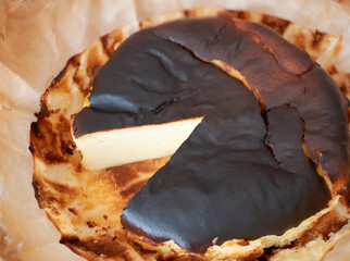 Basque burnt cheesecake with a rich, dark caramelized exterior surface and jiggly middle