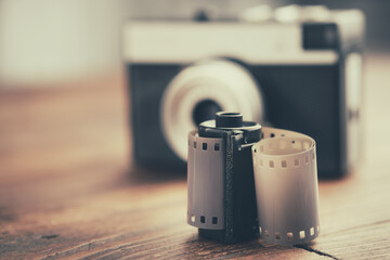 Old photo film rolls, cassette and retro camera on background. - obrazy, fototapety, plakaty
