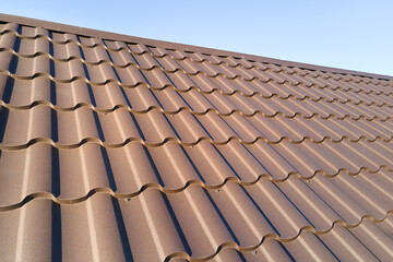 Obraz na płótnie Canvas Closeup of house roof top covered with metallic shingles