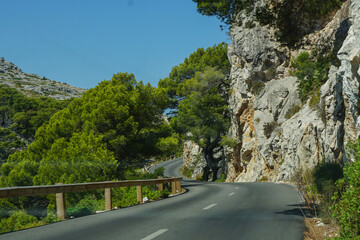 Empty asphalt road in green beautiful mountains, driving on vacation, copy space, traveling concept