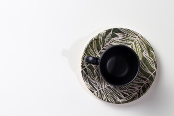 Black cup with green saucer top view