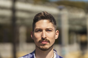 Obraz premium portrait of young white man with beard, piercings and blue eyes