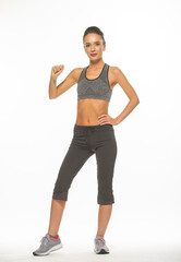 Naklejka premium athletic girl in training clothes posing on a white background in the studio in full growth 