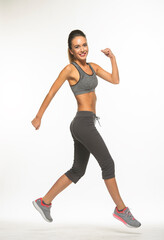 athletic girl in training clothes posing on a white background in the studio in full growth
