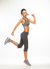 athletic girl in training clothes posing on a white background in the studio in full growth
