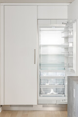 Modern White Kitchen. Custom built white refrigerator with double doors. Empty fridge for staging.