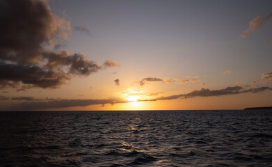 sunset over the sea pink orange gold sky