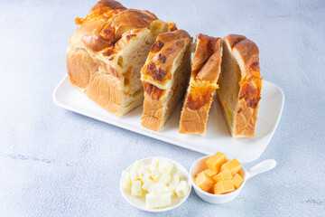 3 cheese braid bread, mozzarella, cheese, yellow cheese displayed on gray background