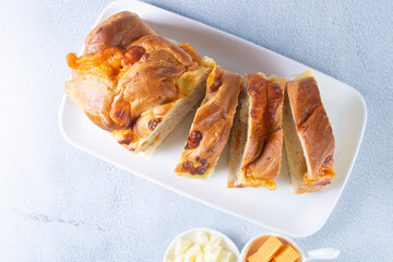 3 cheese braid bread, mozzarella, cheese, yellow cheese displayed on gray background