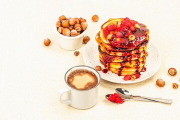 Traditional homemade breakfast with pancakes and coffee. Raspberry, hazelnut, sweet jam