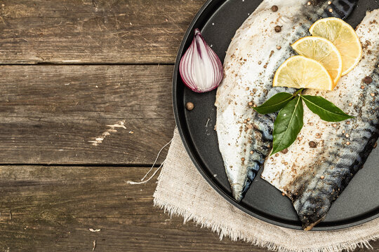 Marinated mackerel with spices and fresh bay leaves. Healthy food, ready to eat, served with lemon