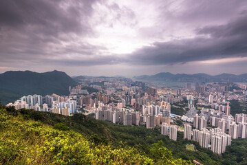 View of the Kowloon walled city from Lion Rock hill under a stormy cloudy sky in Hong Kong, China - obrazy, fototapety, plakaty