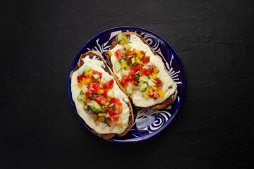 Molletes with Oaxaca cheese and pico de gallo sauce. Mexican food