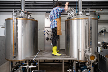 Man working on modern brewery. High quality photography