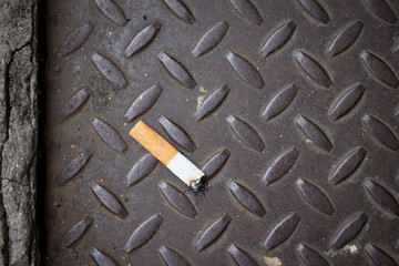 Cigarette thrown on the floor and crushed. Cigarette discarded after smoking, cigarette thrown on...