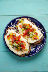 Molletes with Oaxaca cheese and pico de gallo sauce. Mexican food