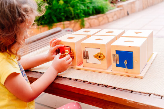 Wooden boxes with locks, educational montessori material to manipulate objects by children with dexterity.