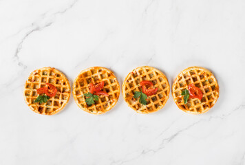 Mini Round waffles pizzas with cheese, ham, tomatoes and parsley. White background. Top view