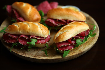 Selective focus. Salami sandwiches with herbs and mustard.