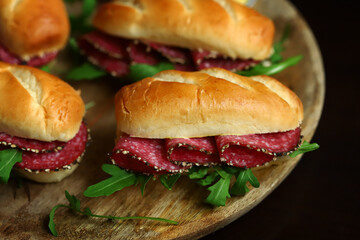 Selective focus. Salami sandwiches with herbs and mustard.