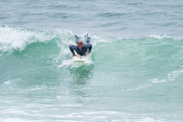 Surfer riding waves