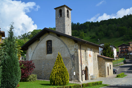 Old parish Church of Ascension in Costa Serina under a blue cloudy sky on a sunny day