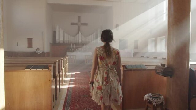 Girl walking in church to cross whole scene.