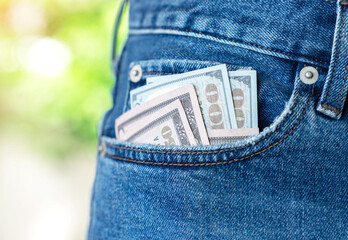 Dollar banknote in jeans pocket.