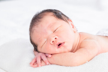 Fototapeta na wymiar Selective focus of Asian little baby peacefully deeply sleeping on white bed with safe, Adorable infant sleep on blanket in bedroom and nature sunlight.Tiny toddler boy soft skin healthy sleep dream.