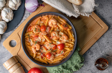 Amazing pasta pene with shrimps and tomato sauce with herbs