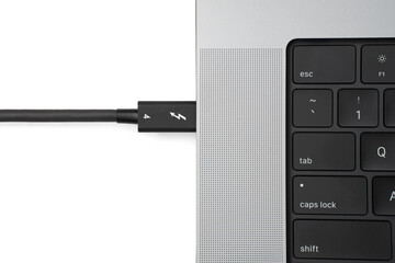 Thunderbolt 4 Cable Plugged Into Open Charging Laptop Computer Isolated on White Background with Shadow