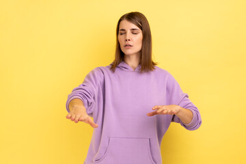 Portrait of woman with eyesight problems trying to move with closed eyes touching space around with...