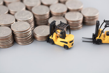 Miniature creative forklift carrying coins