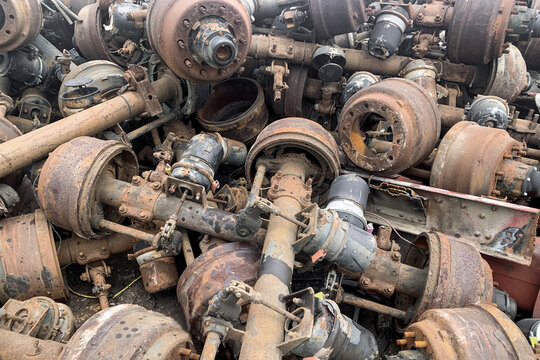 Pile Of Old Rusty Truck Axle For Reusing, Used Automotive Part For Sale, Old Rear Differential Of Truck, Car Rear Axle On Junk Yard