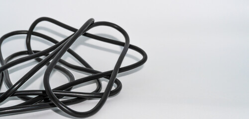 Closeup shot of black tangled wires isolated in a white background