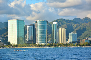 Honolulu and Waikiki city skyline view with mountains in the background and ocean in the foreground on Oahu, Hawaii