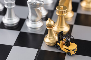 Forklift moves chess pieces on the miniature world chessboard