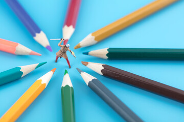 Samurai fighting surrounded by colored pencils in miniature